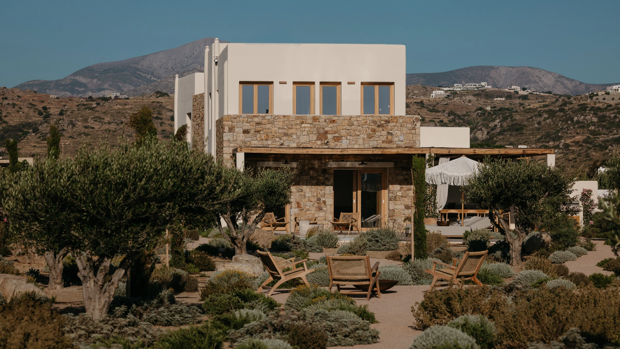 The house above its garden, mountains beyond