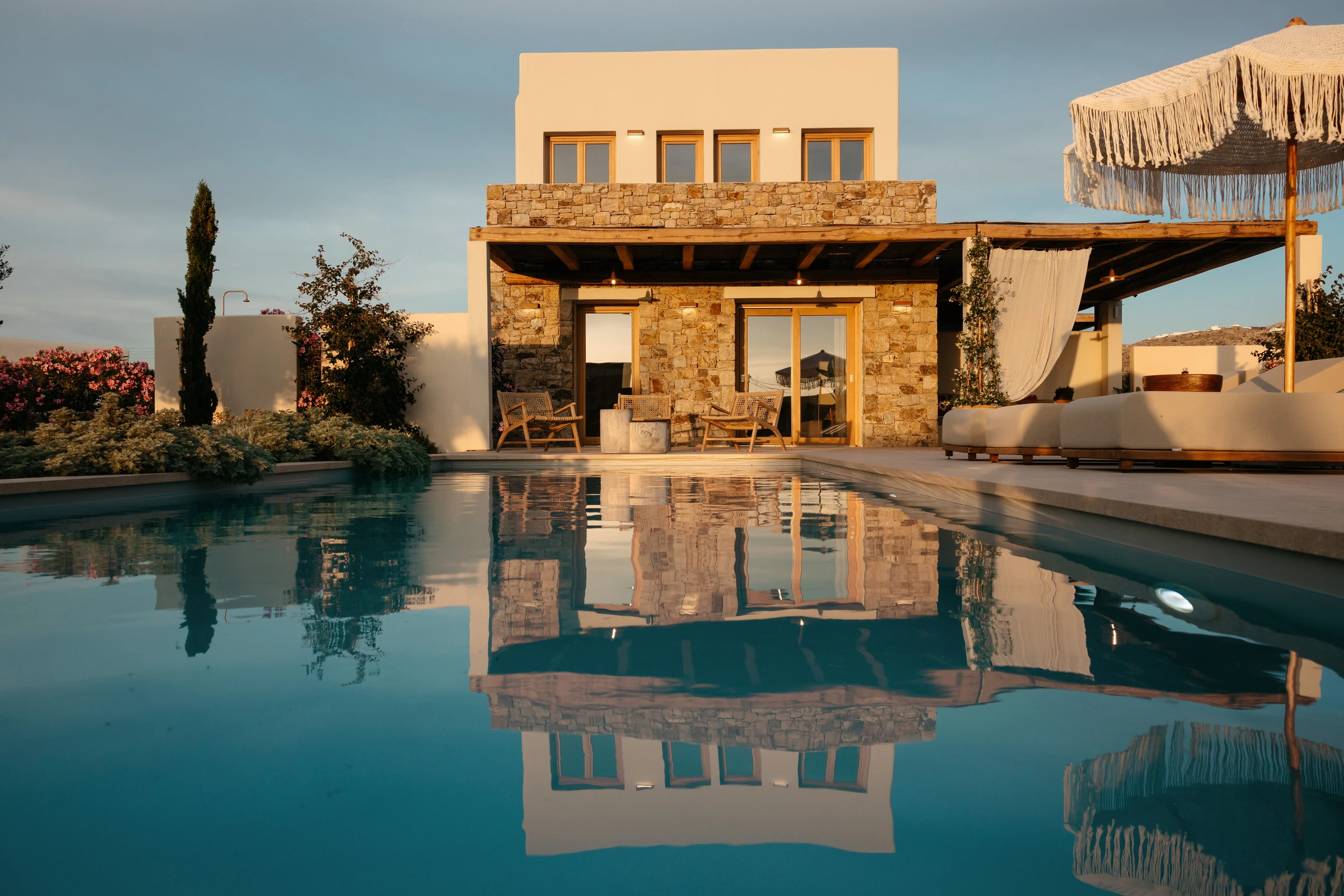 The house reflected in the pool at dusk