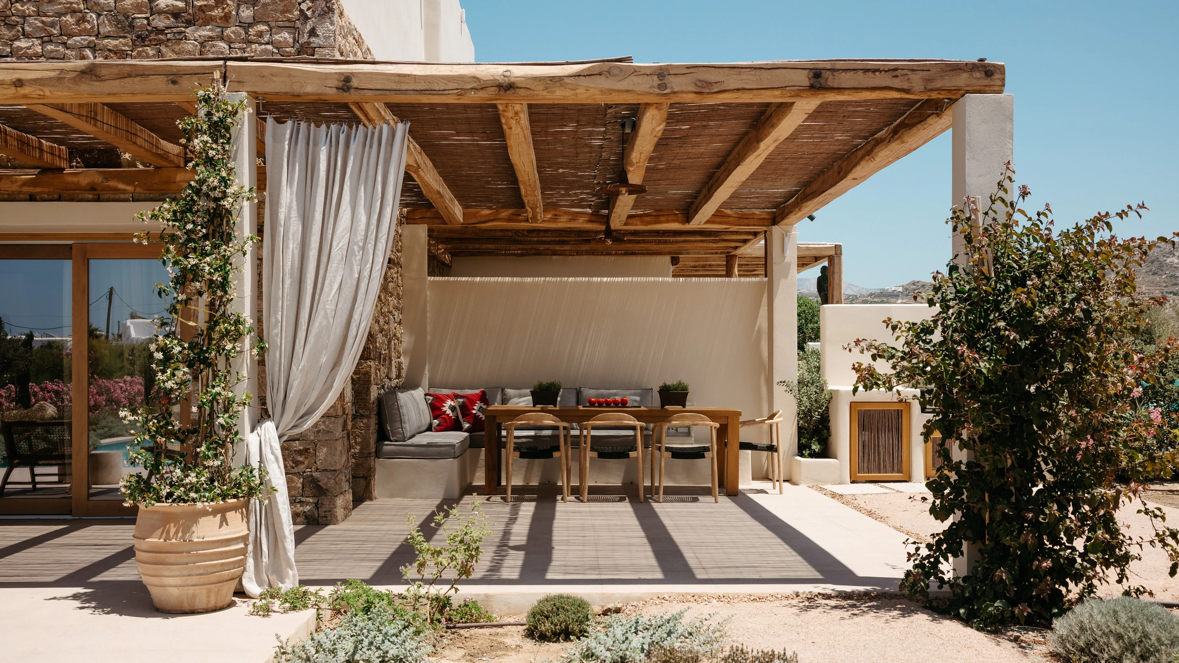 The pergola terrace with linen drapes and stone