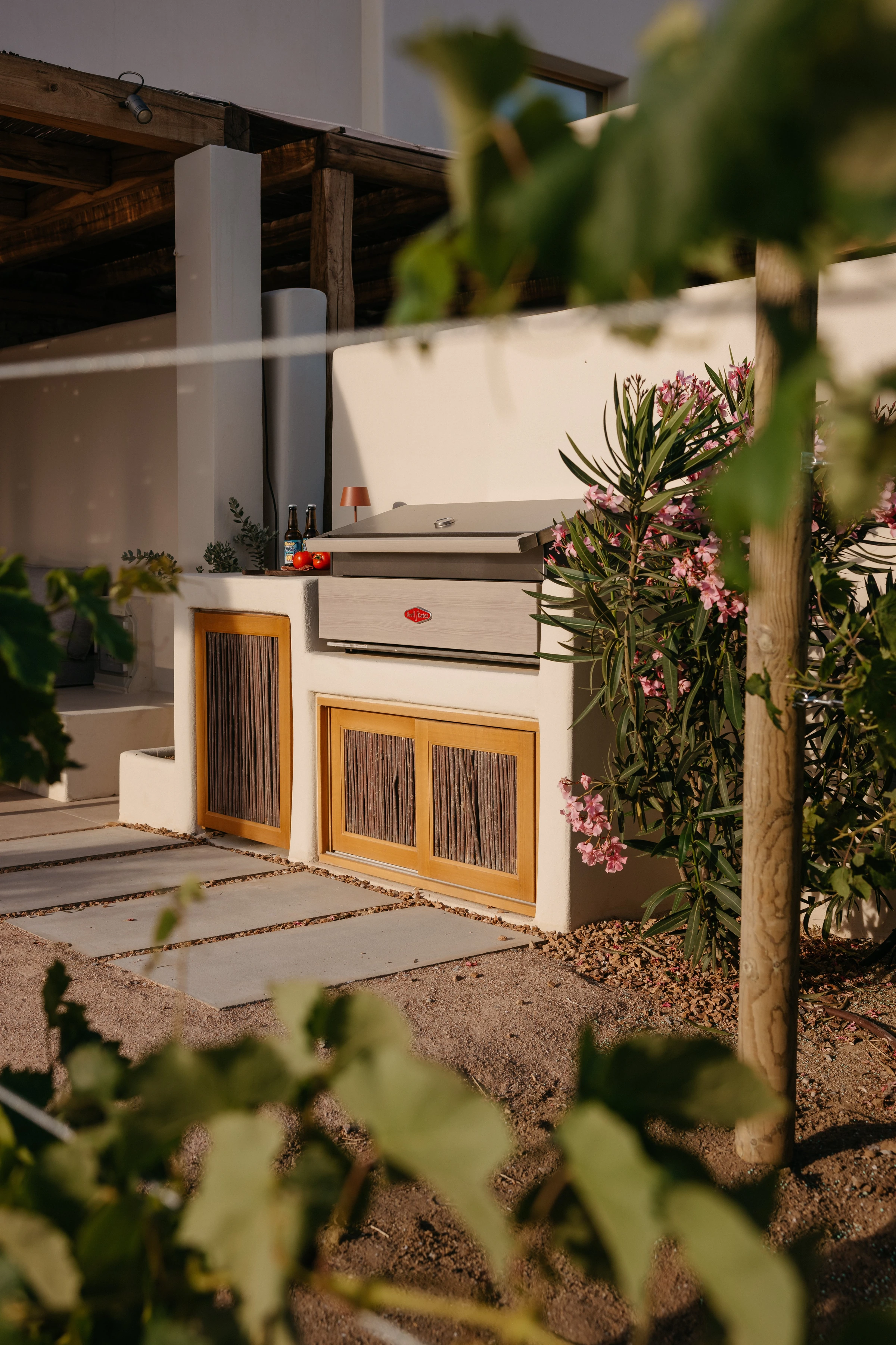 The built-in grill station framed by oleander