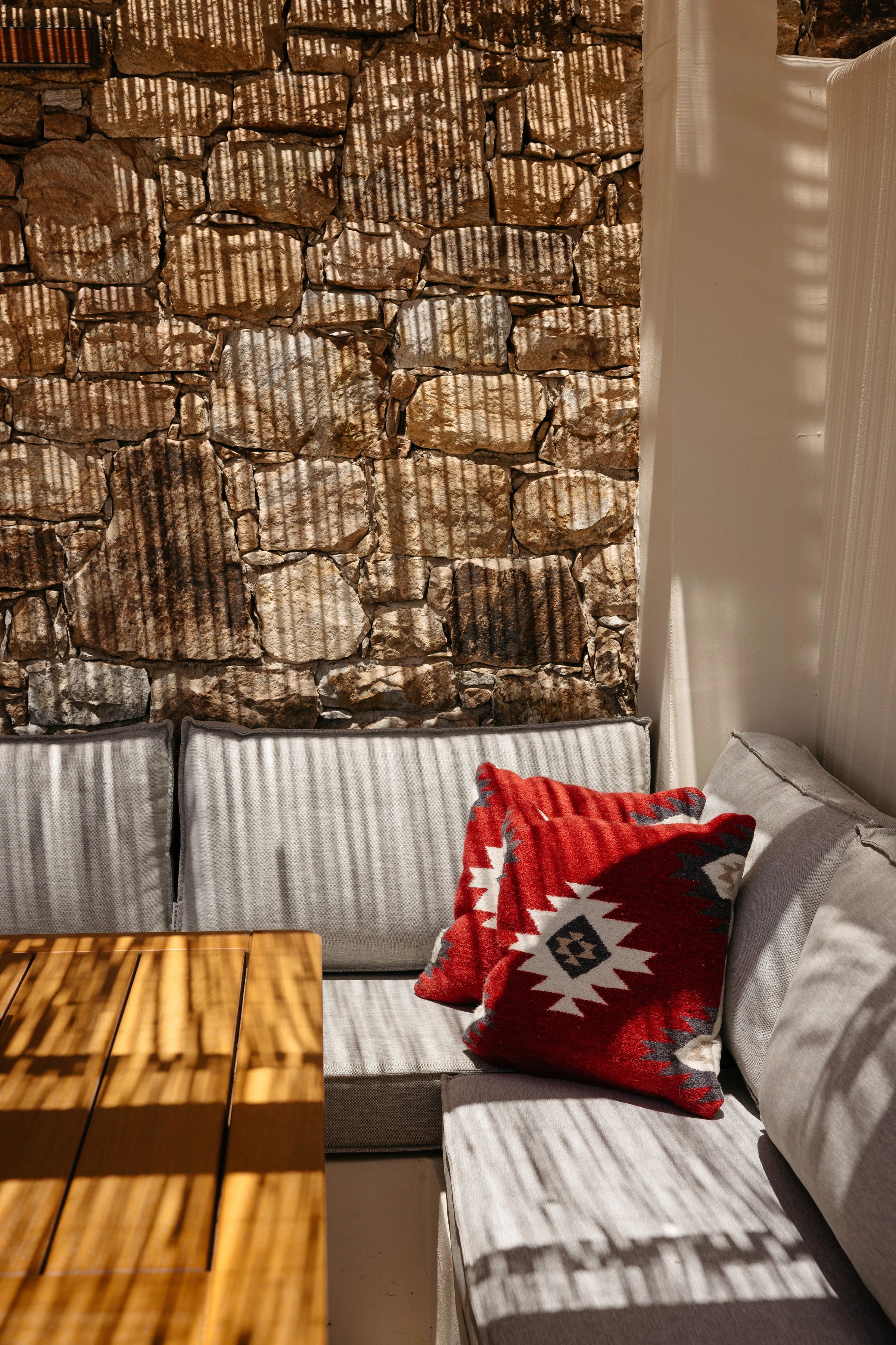 The corner banquette with red kilim cushions