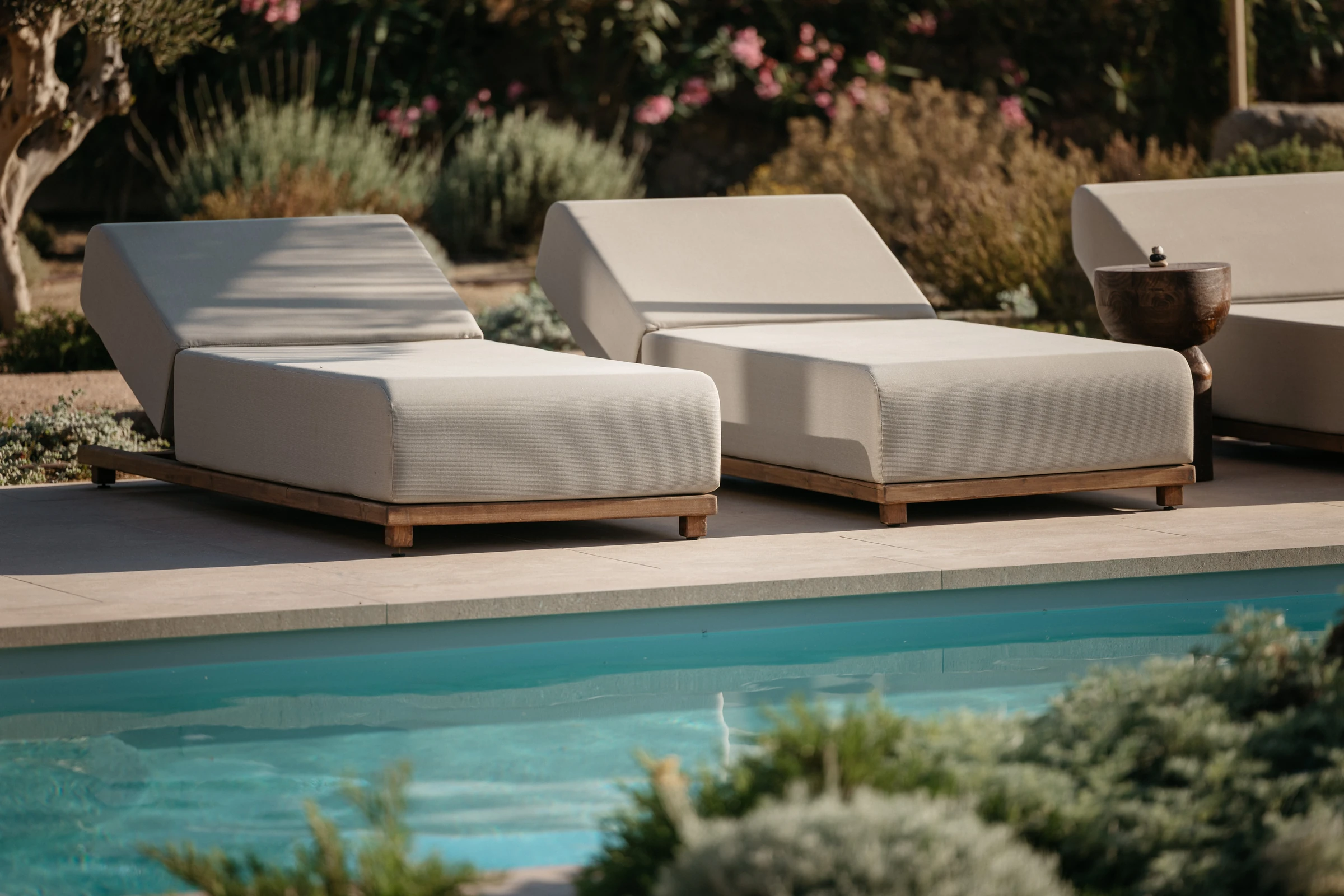 Poolside loungers in the late afternoon light
