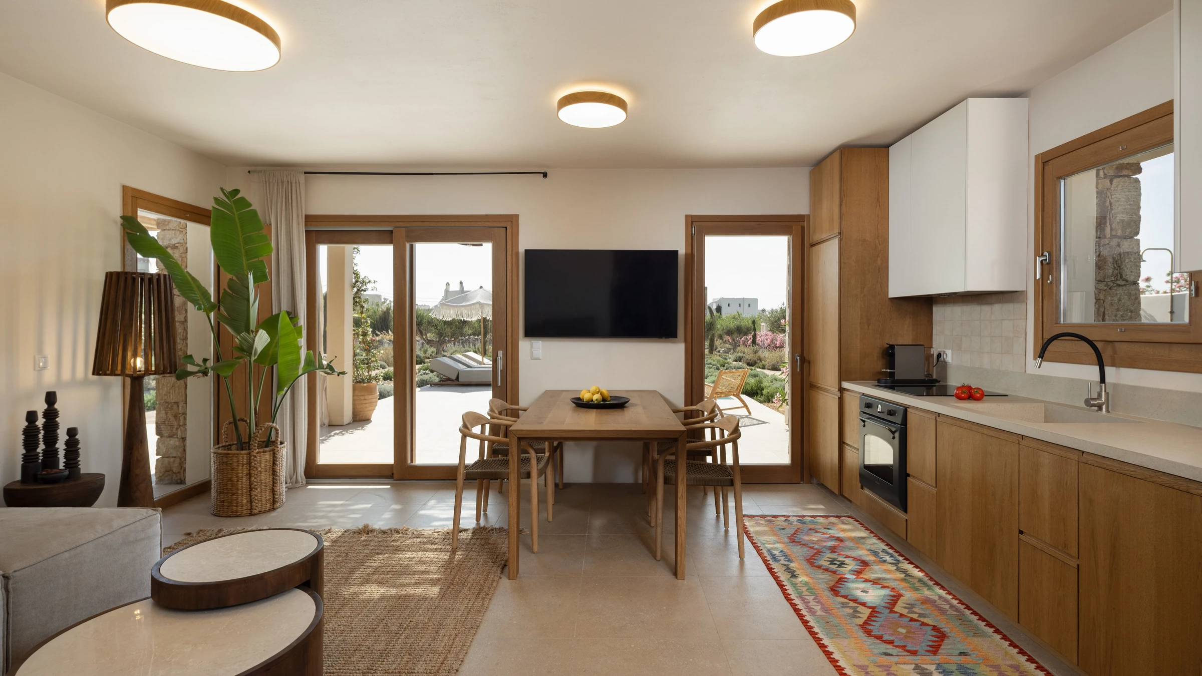 Open-plan living, dining and kitchen with terrace beyond