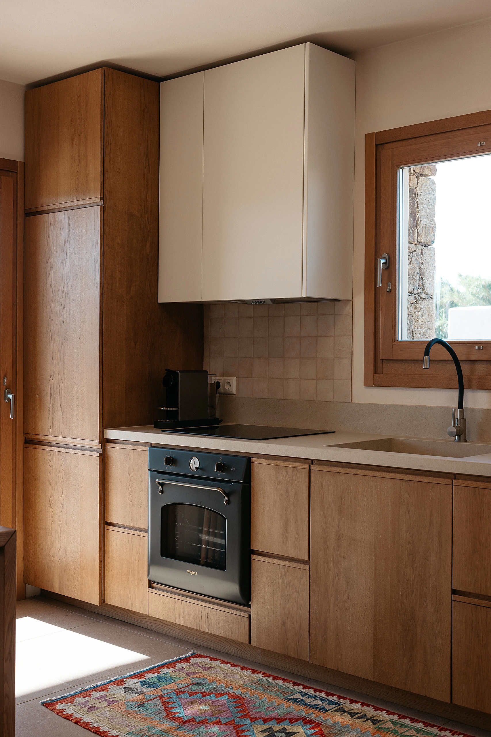 Kitchen detail: timber cabinets, oven and window